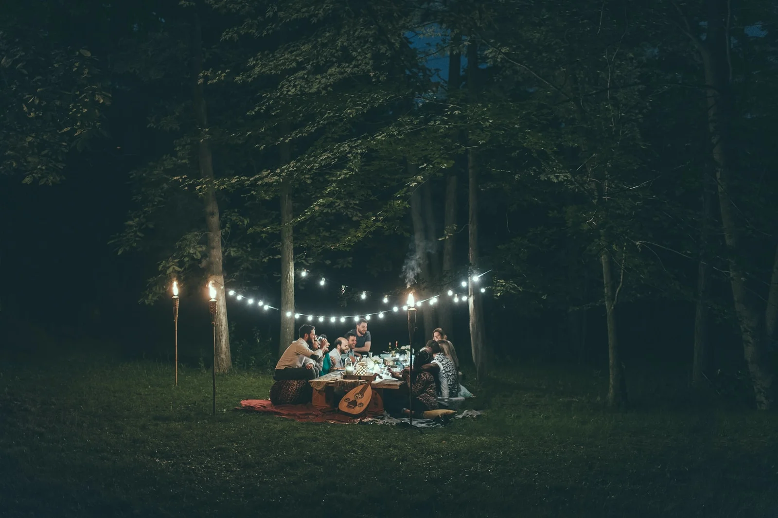 people sitting on red swing during night time