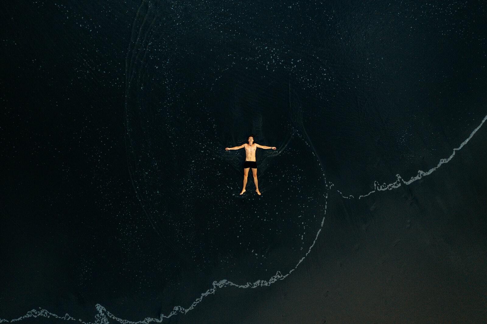 man lying on water