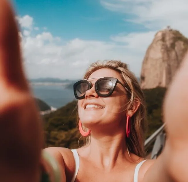 woman in white tank top wearing black sunglasses